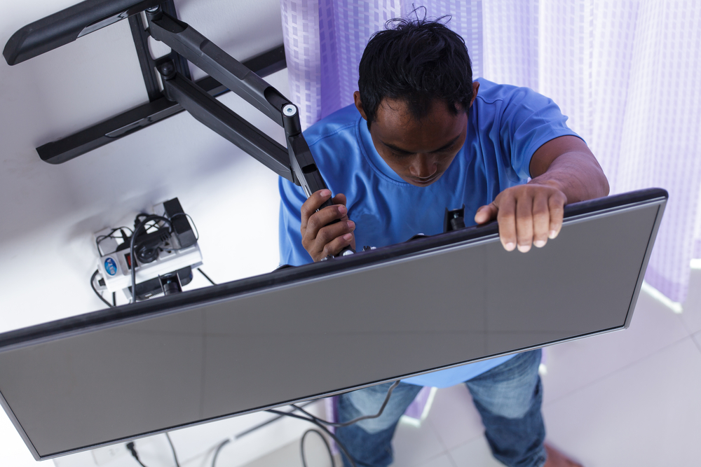 Sort a home UK homeowners man-installing-tv-mount